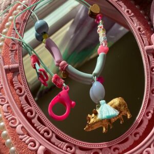 Animalitos Necklaces. Cute, fun and soft combination between mint green, lavander,golden pig, and some touches of pink. delicate silk thread with pink velvet at the ends with a special paste brooch. size: 12 in.